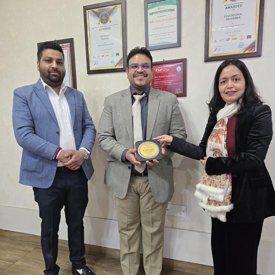Dr. Mohit Gupta honoured after a kids dental camp at Alliance International School