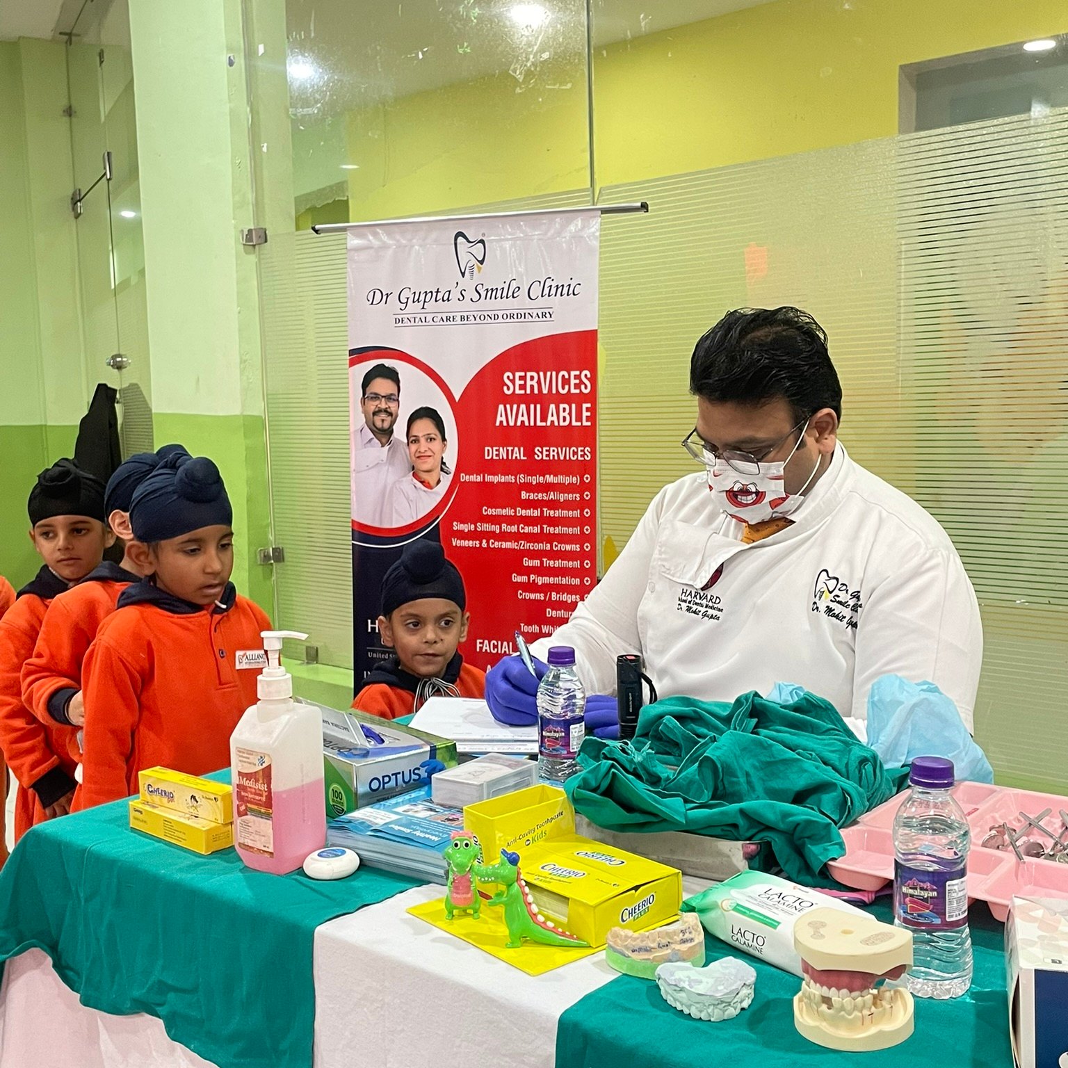 Dr. Mohit Gupta checking children's teeth at a dental camp