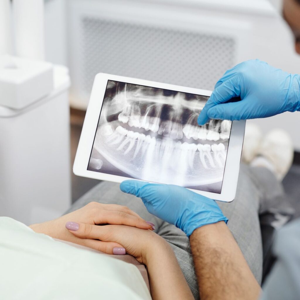Dentist explaining a dental X-ray before root canal treatment